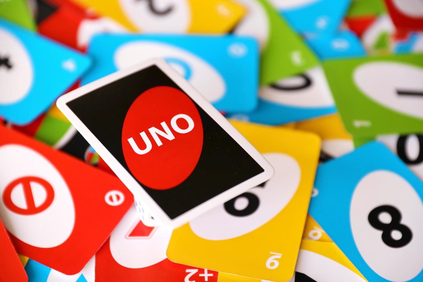 TERNOPIL, UKRAINE - MAY 15, 2022 Many colorful UNO game cards. UNO is an American shedding-type card game that is played with a specially printed deck photo