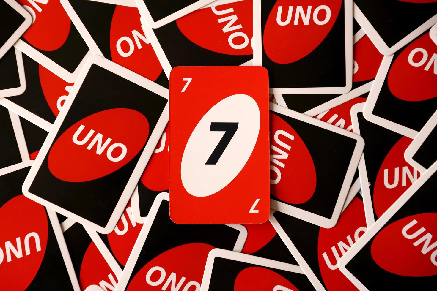 TERNOPIL, UKRAINE - MAY 15, 2022 Many colorful UNO game cards. UNO is an American shedding-type card game that is played with a specially printed deck photo