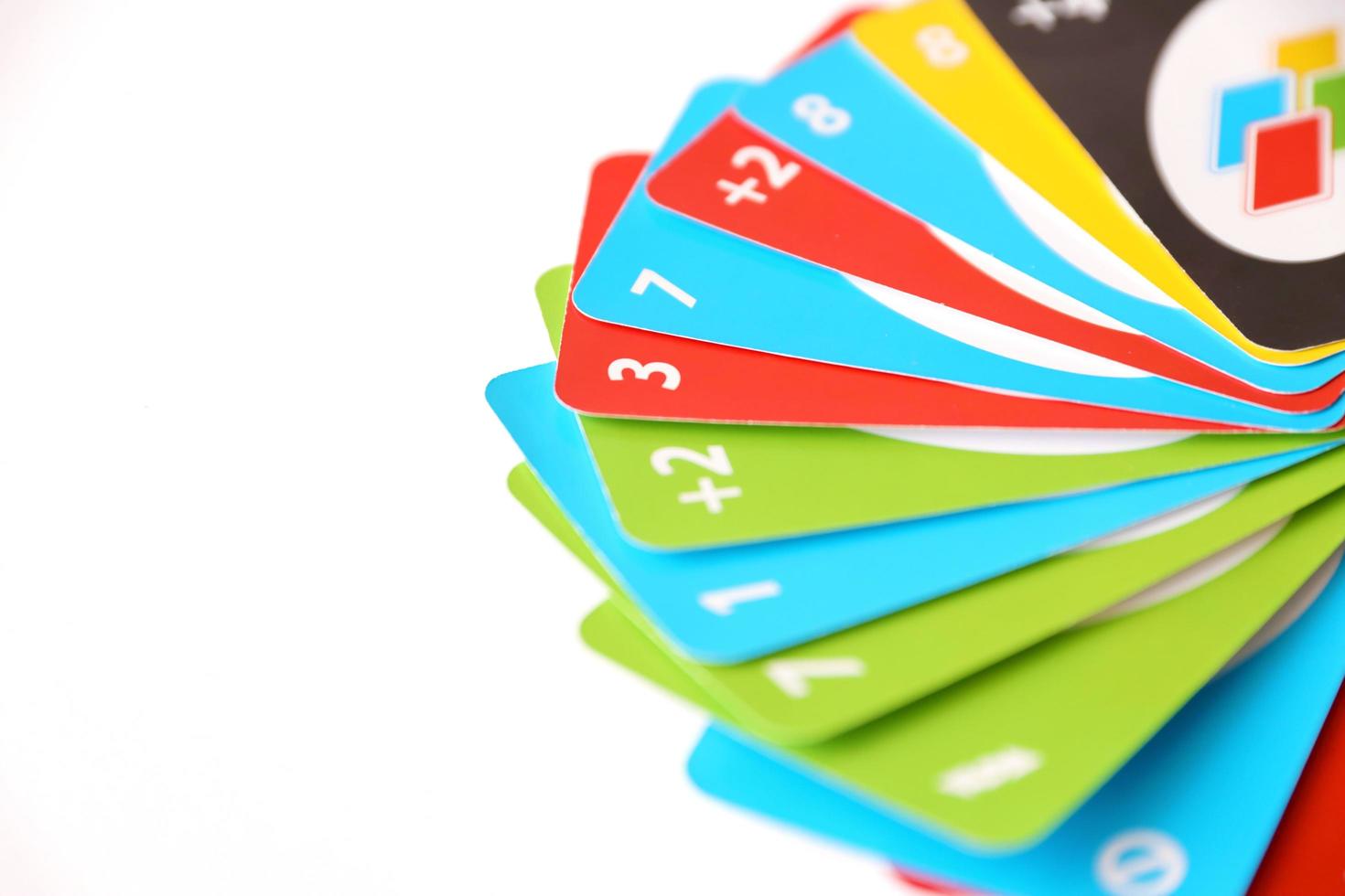 TERNOPIL, UKRAINE - MAY 15, 2022 Many colorful UNO game cards on white background. UNO is an American shedding-type card game that is played with a specially printed deck photo