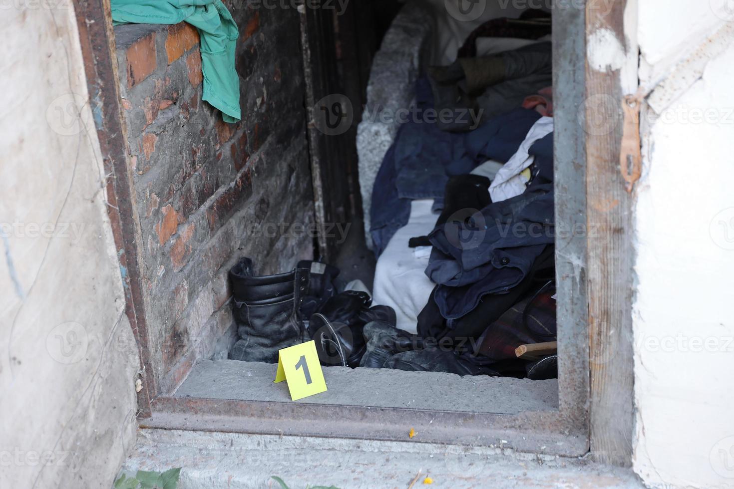 Evidence with yellow CSI marker for evidence numbering on the residental backyard in evening. Crime scene investigation concept photo