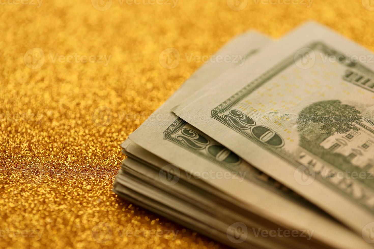 Big amount of old twenty dollar bills on golden background. Money earnings, payday or tax paying period photo