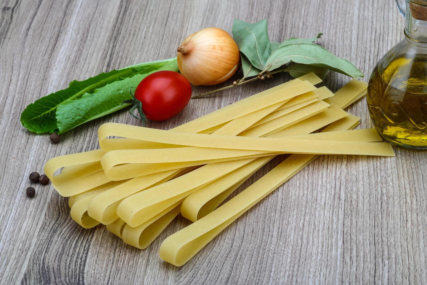 Fettuccine on wooden background photo