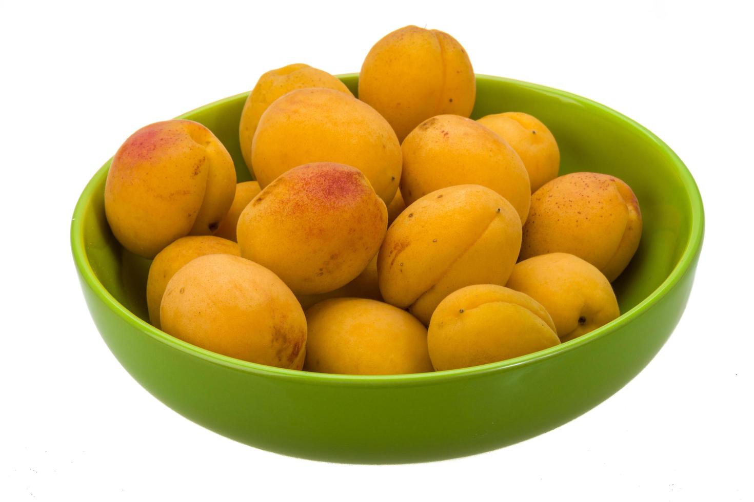 Ripe apricots on white photo