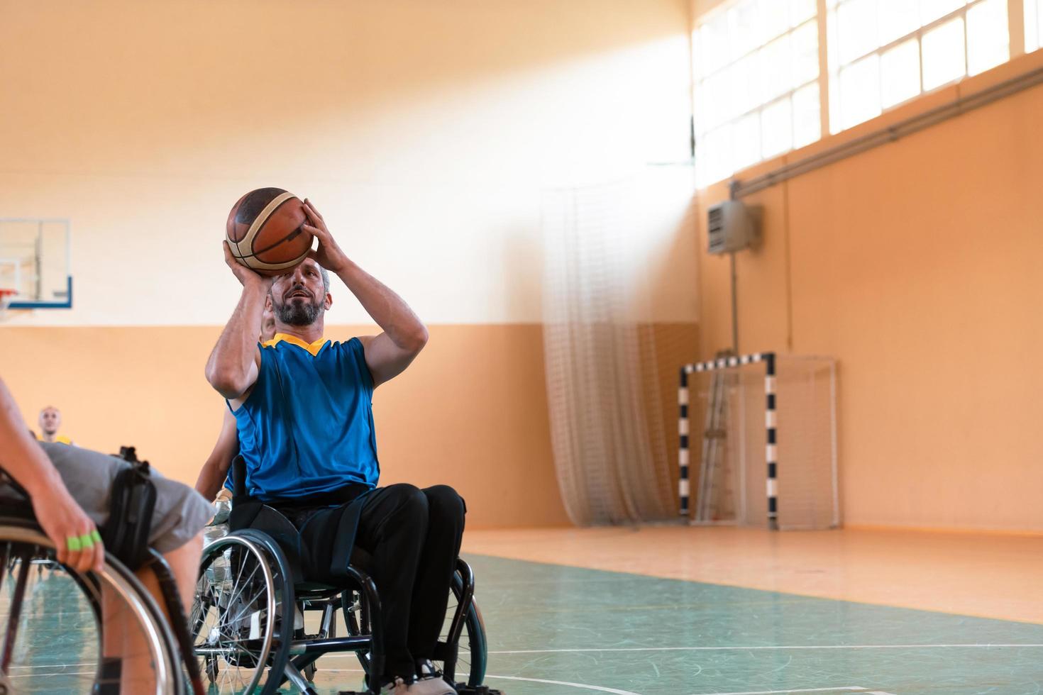 Close up photo of wheelchairs and handicapped war veterans playing basketball on the court