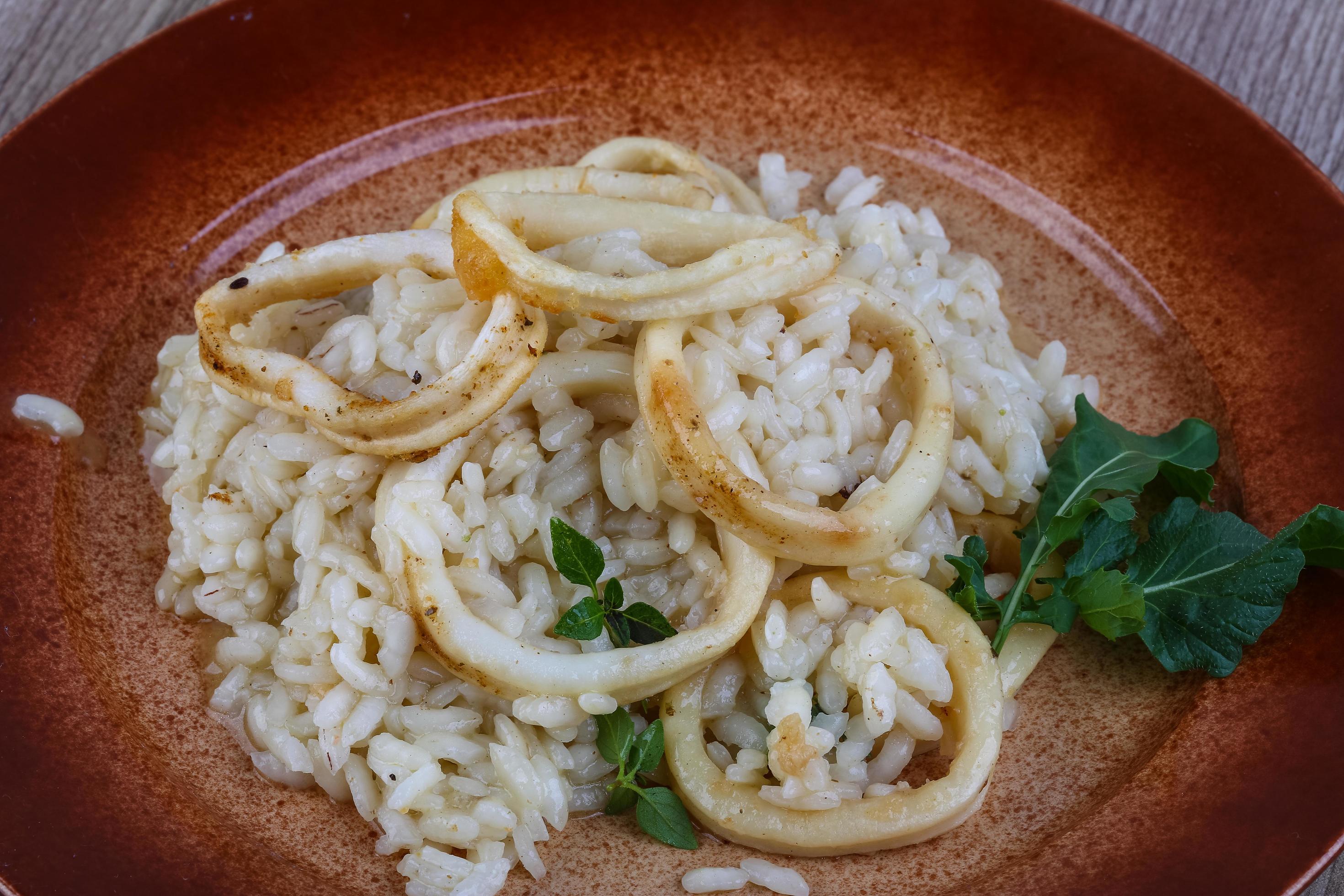 Squid risotto view 12888272 Stock Photo at Vecteezy