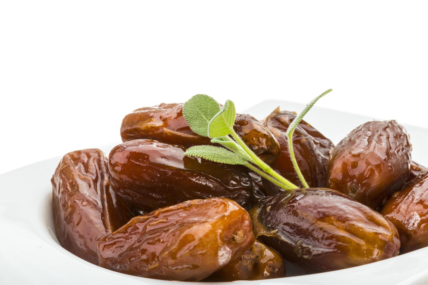 Dates in a bowl on white background photo