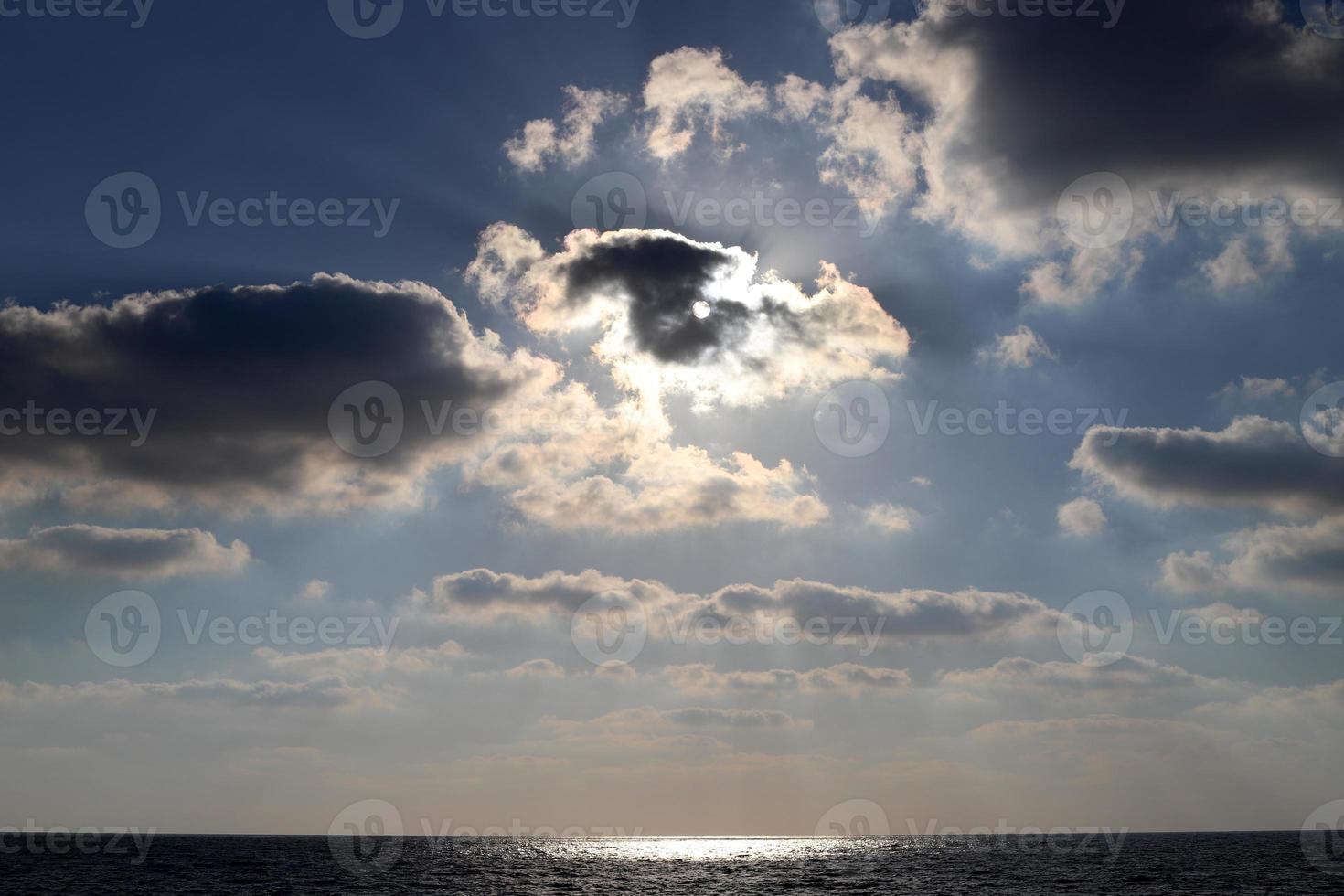 Large rain clouds in the sky over the sea. photo
