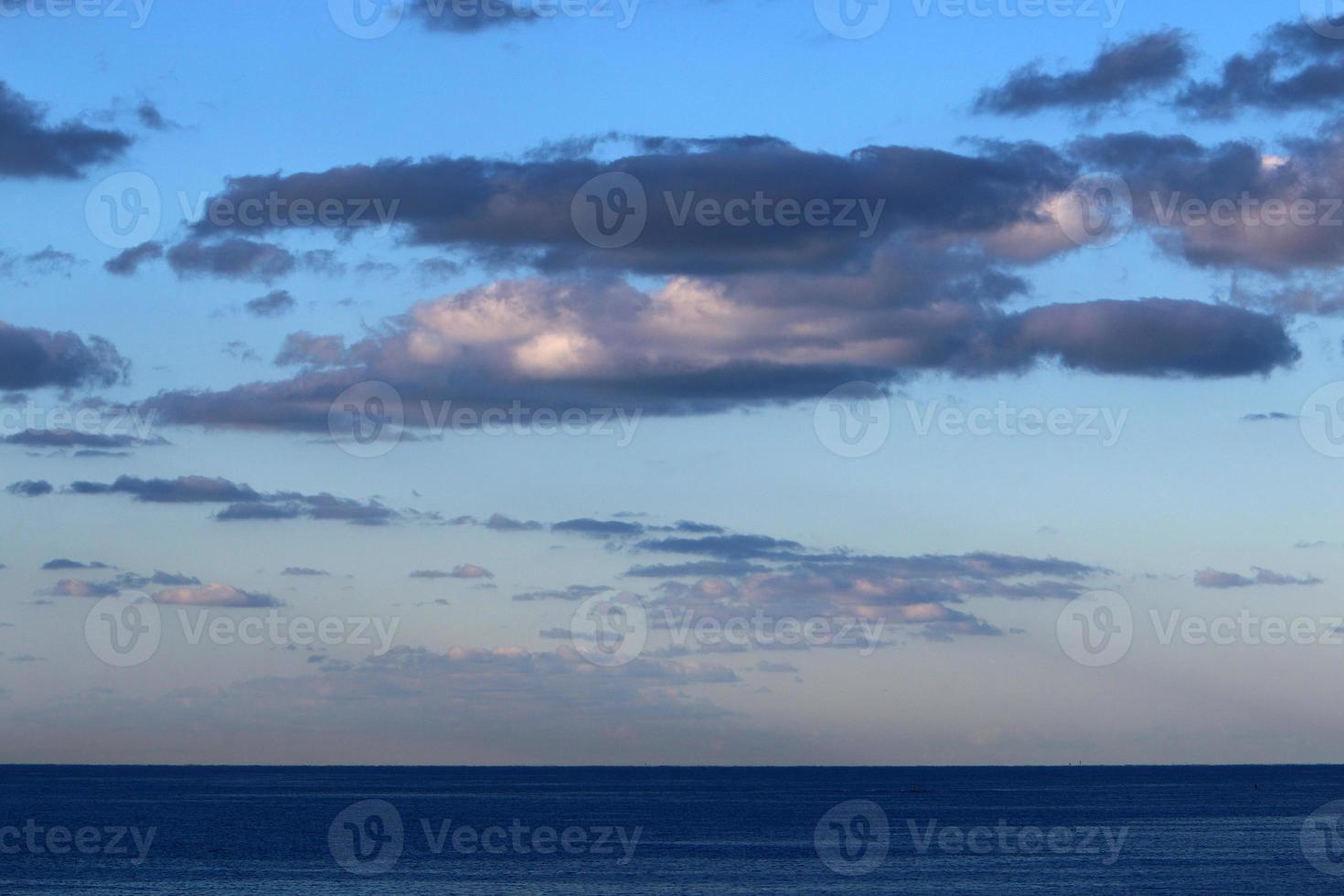 Large rain clouds in the sky over the sea. photo