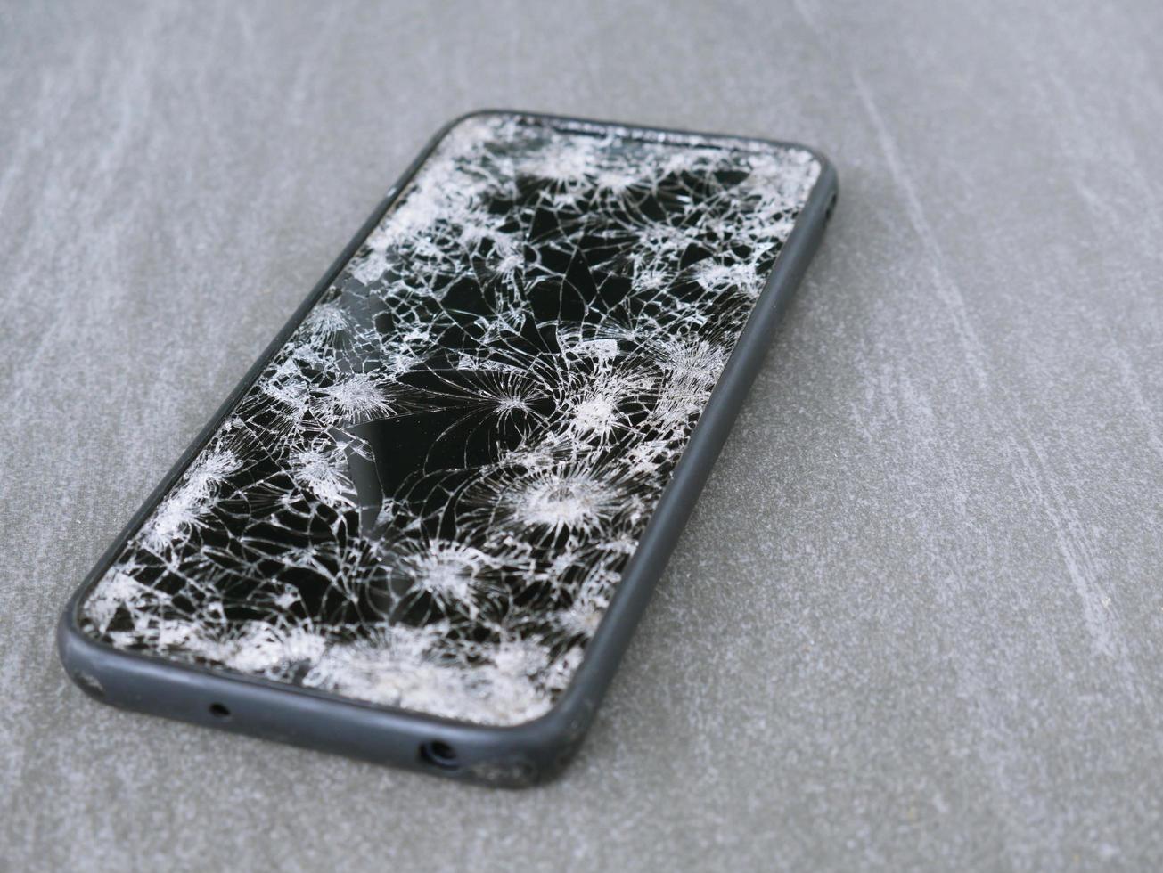 The smartphone hit the floor, it fell into a crack. photo