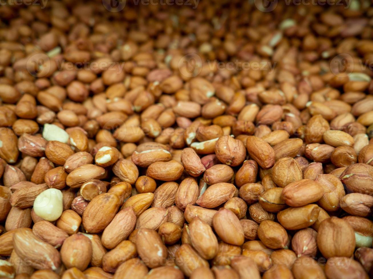 Peanut background. Healthy diet. Lots of nuts in the box. photo