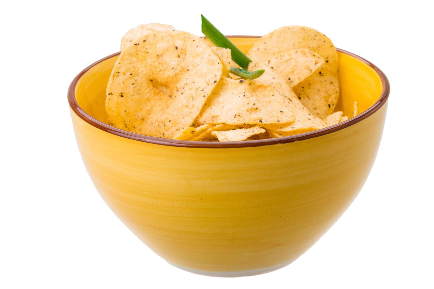 Potato chips in a bowl on white background photo