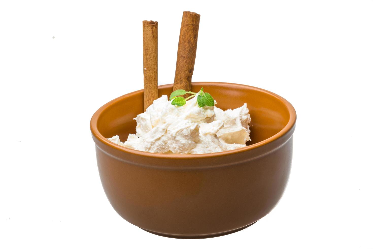 Cottage cheese in a bowl on white background photo