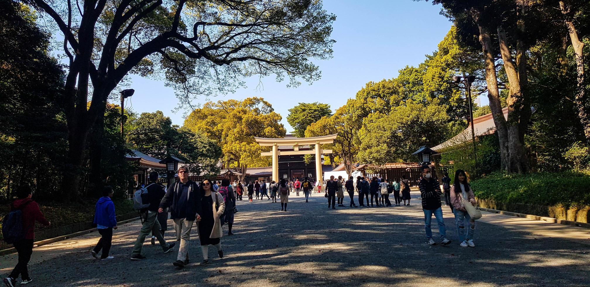 Japan on April 2019. Tourists walking at the entrance of the Harajuku City Forest heading to Meiji Shrine. photo