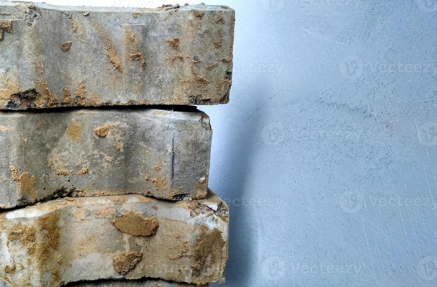 A lot of gray street bricks are standing in a pile photo