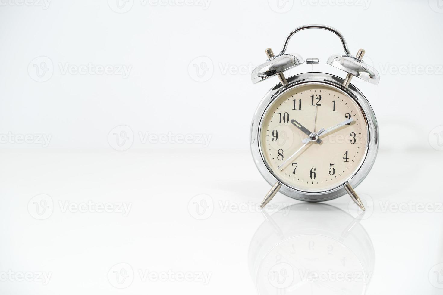 Silver alarm clock  on white photo