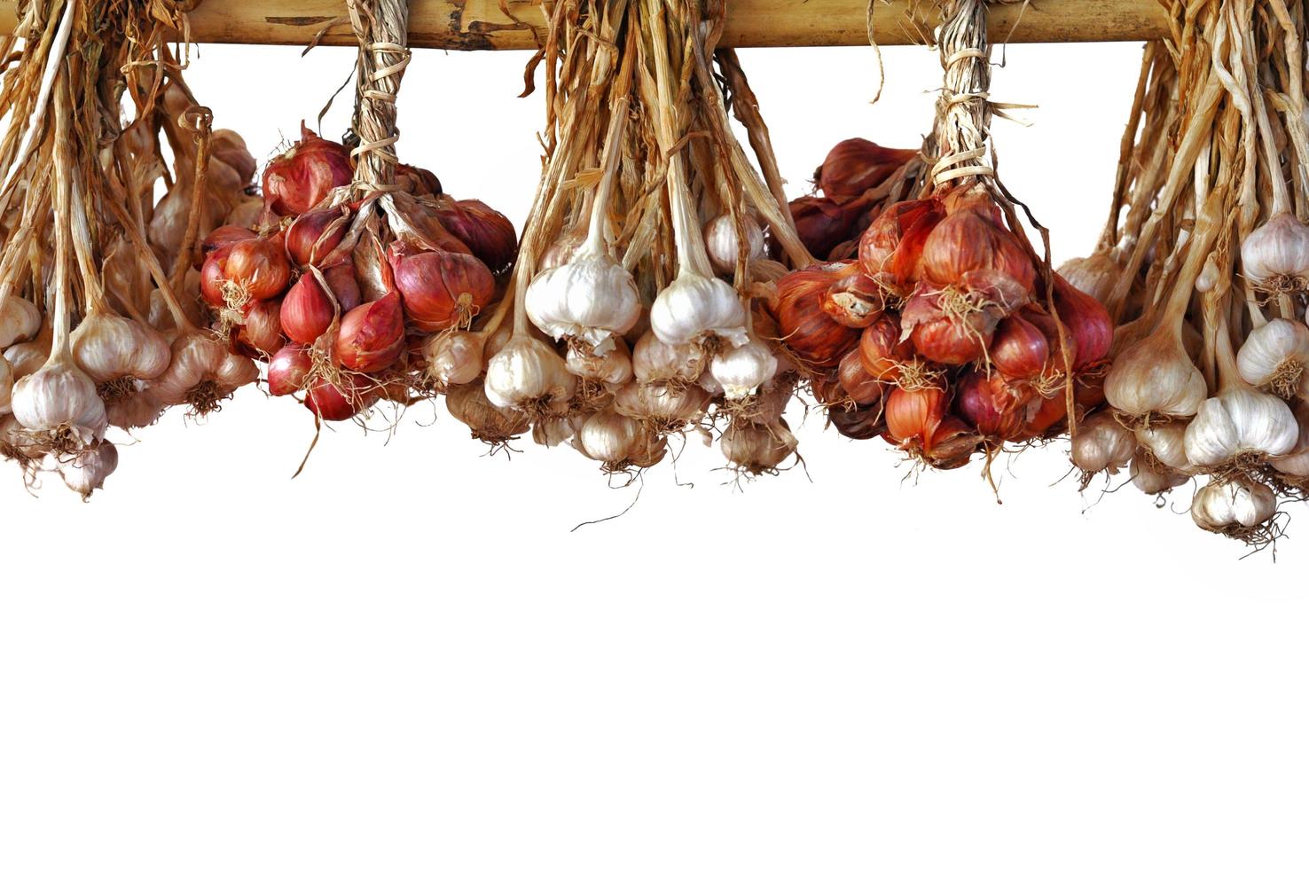 Garlic and shallot or small red onion from Thailand hanging to dry on