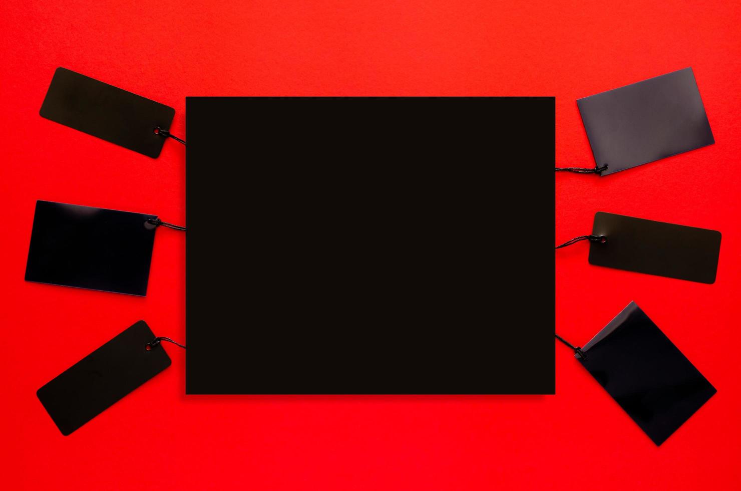 Black price tags with black space for text on red background. Black friday concept. photo