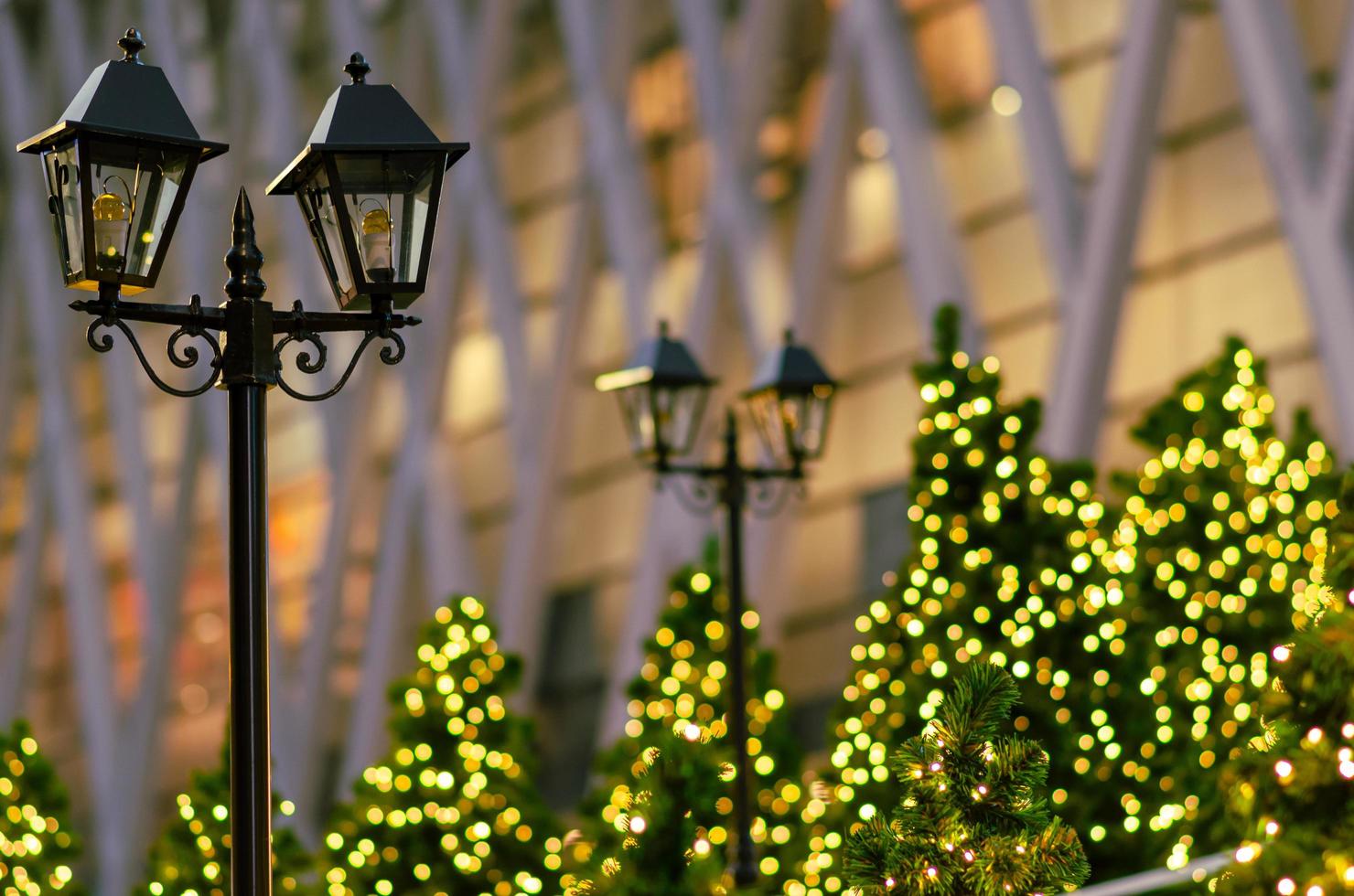 Lantern with blurred colorful Christmas tree in background for Christmas holiday festival. photo