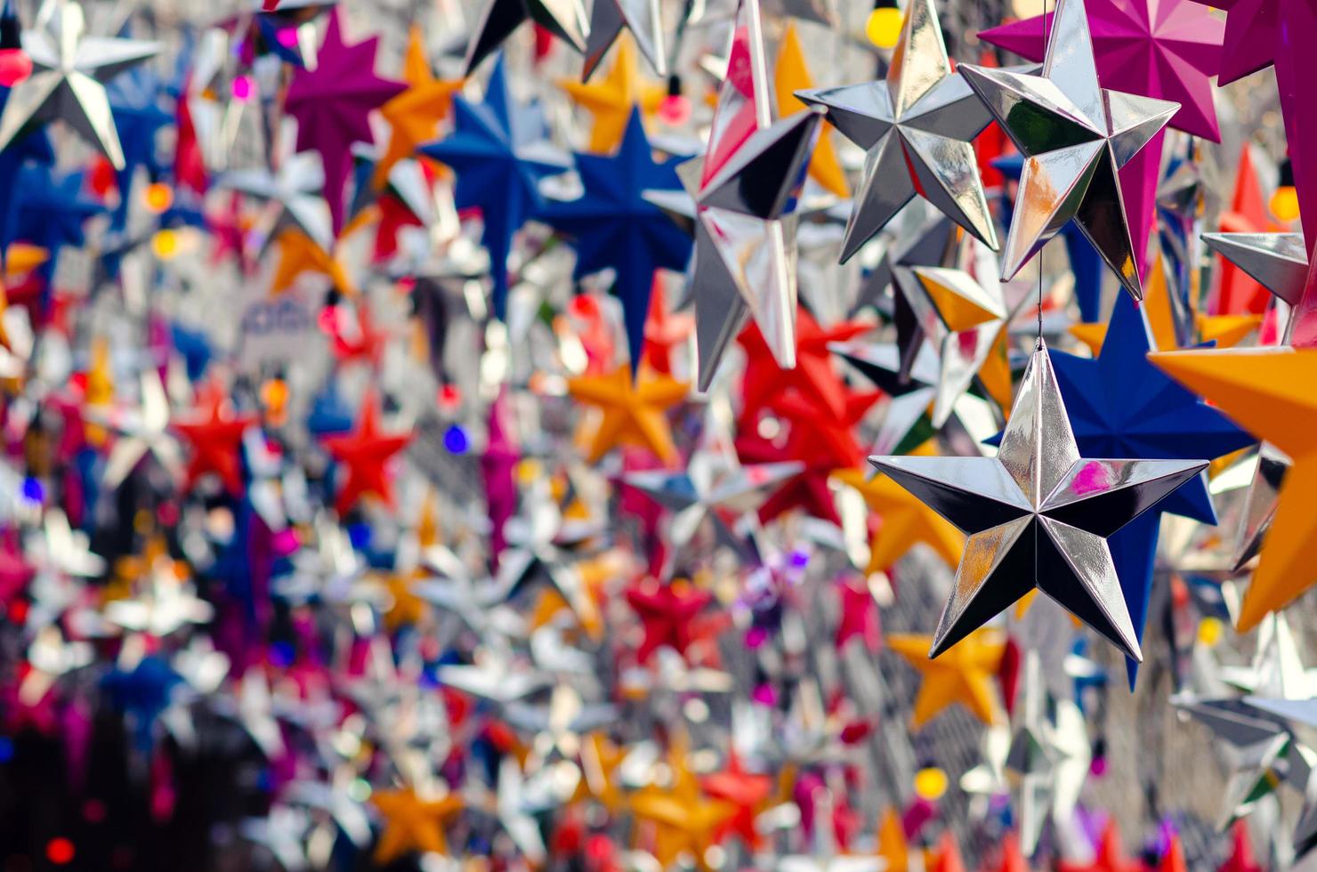 Colorful star ornaments hanging to decorate for Christmas holiday. photo