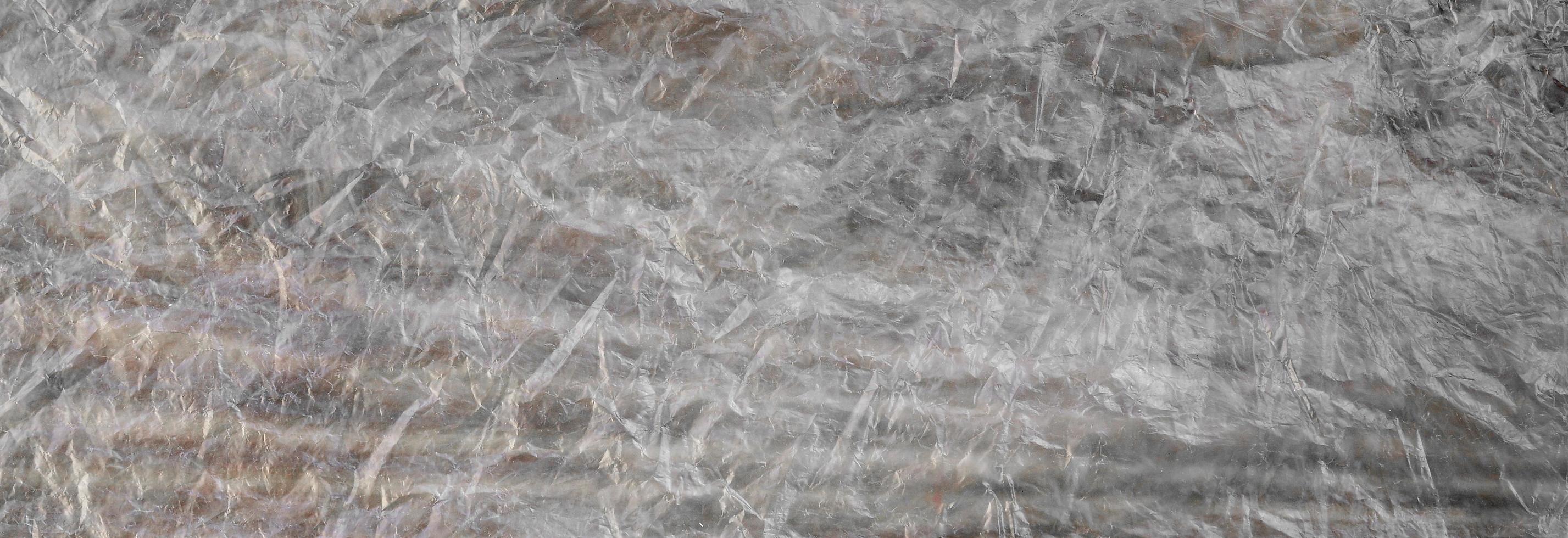 Texture of cellophane material with many folds and bends photo