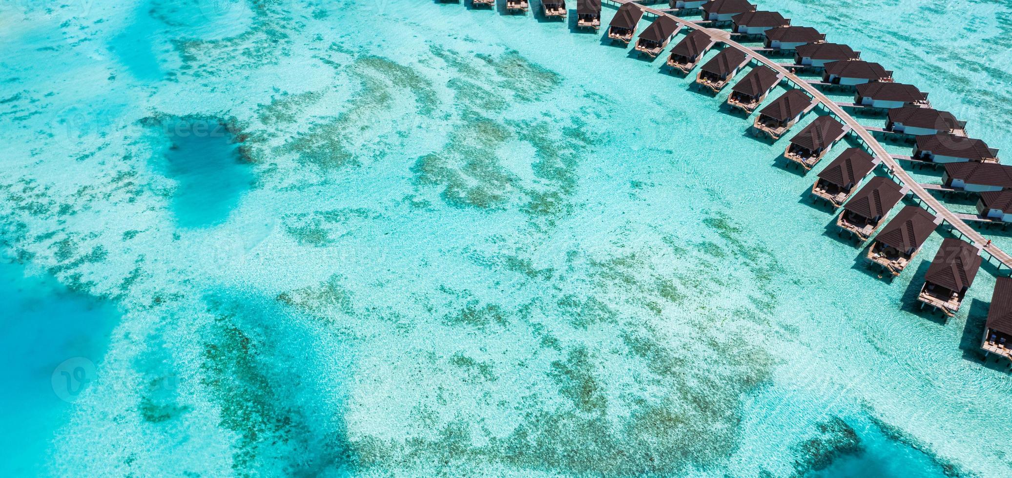 Beautiful panoramic Maldives paradise. Tropical aerial travel wide landscape, wooden bridge, water villas, amazing sea sand sky beach, tropical island nature. Exotic tourism summer vacation panorama photo