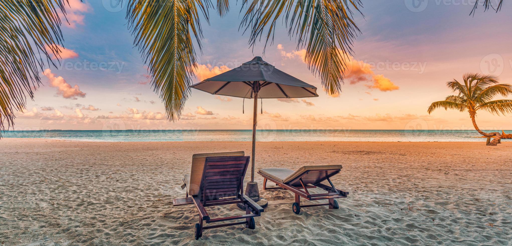 Amazing beach. Chairs on the sandy beach sea. Luxury summer holiday vacation resort as tourism design. Panoramic tropical landscape. Tranquil scenery, relaxing beach, romantic couple paradise panorama photo