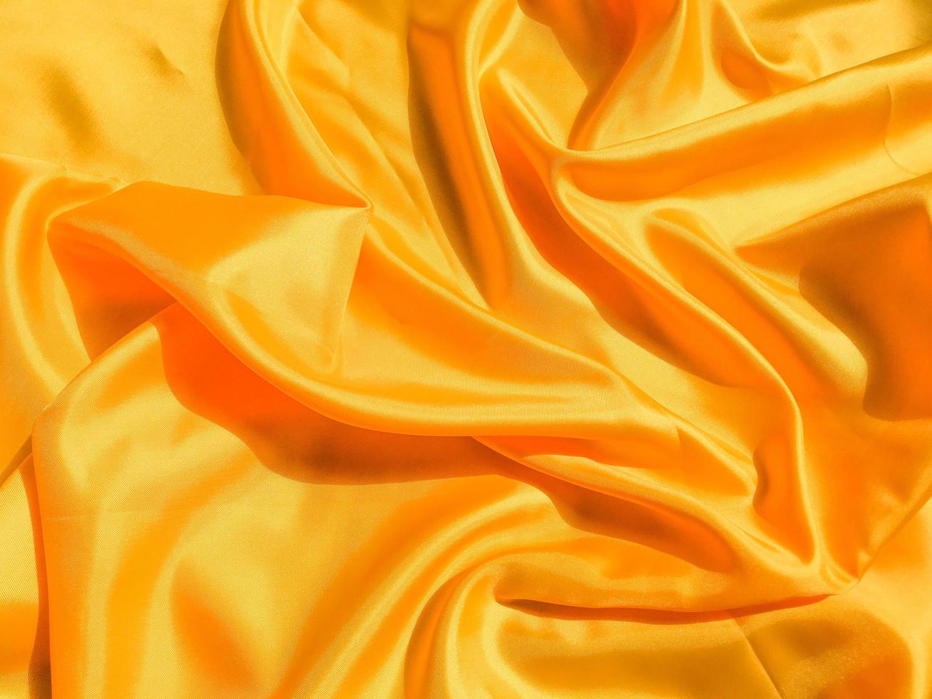 Yellow silk or satin texture background with copy space for design