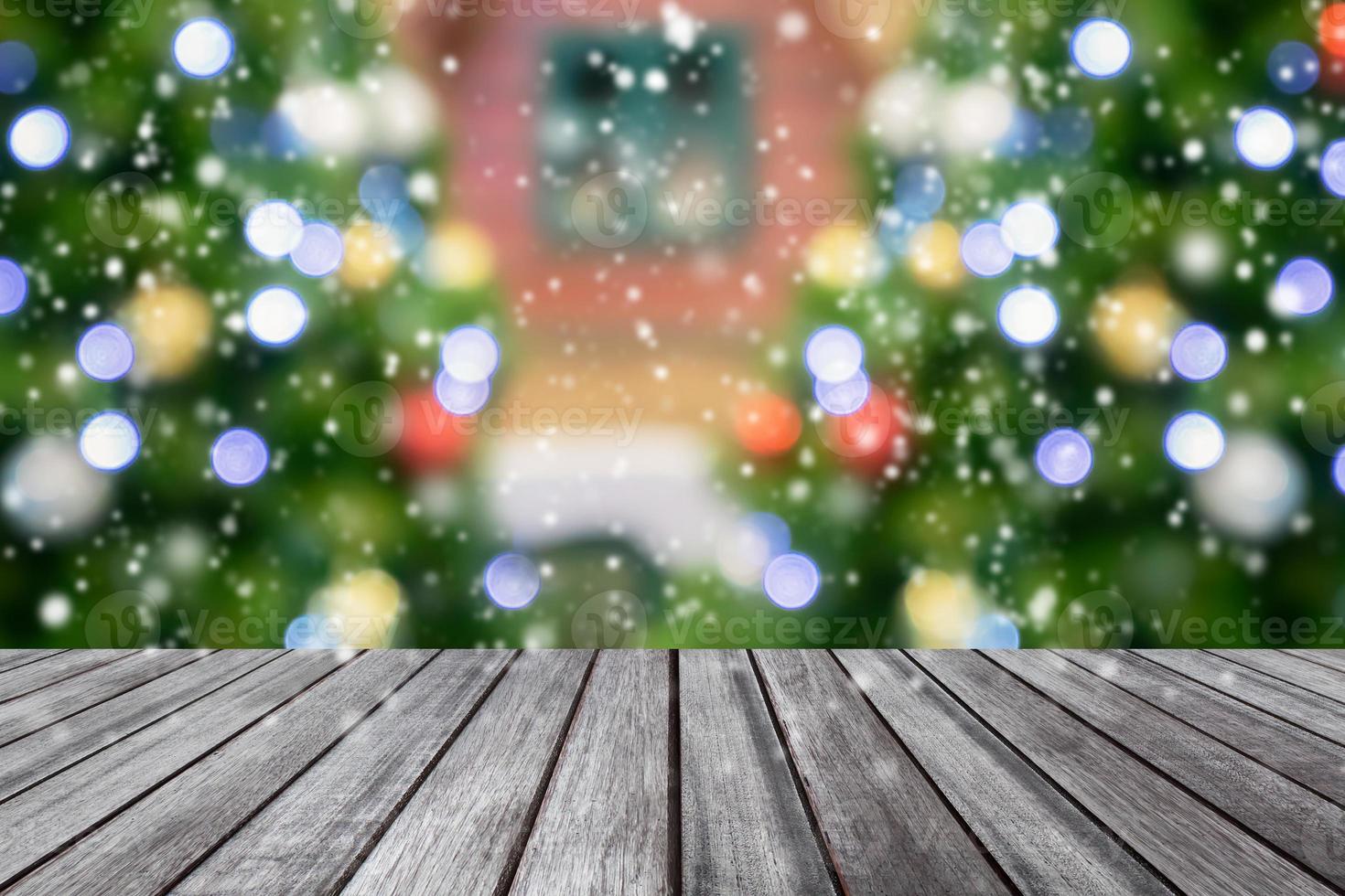 Empty wooden table top with blurred Christmas tree background photo