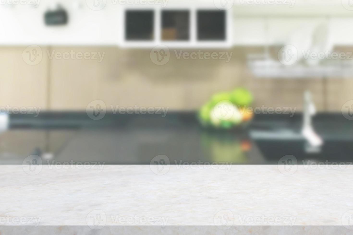 white marble stone counter top with blurred kitchen background photo