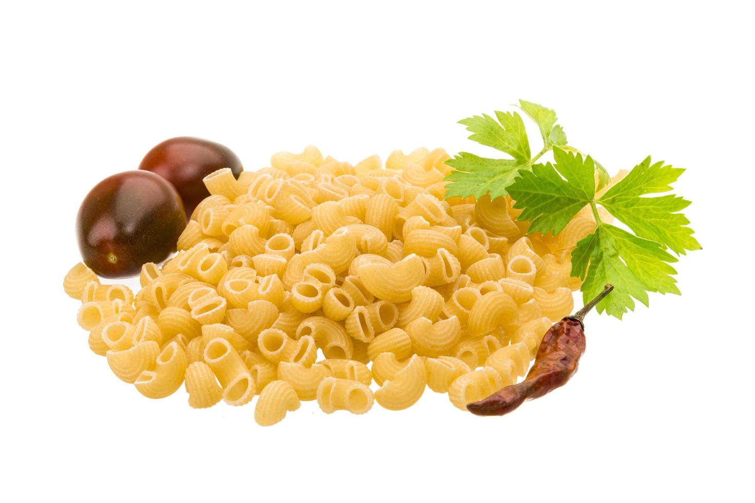 Raw macaroni on white photo