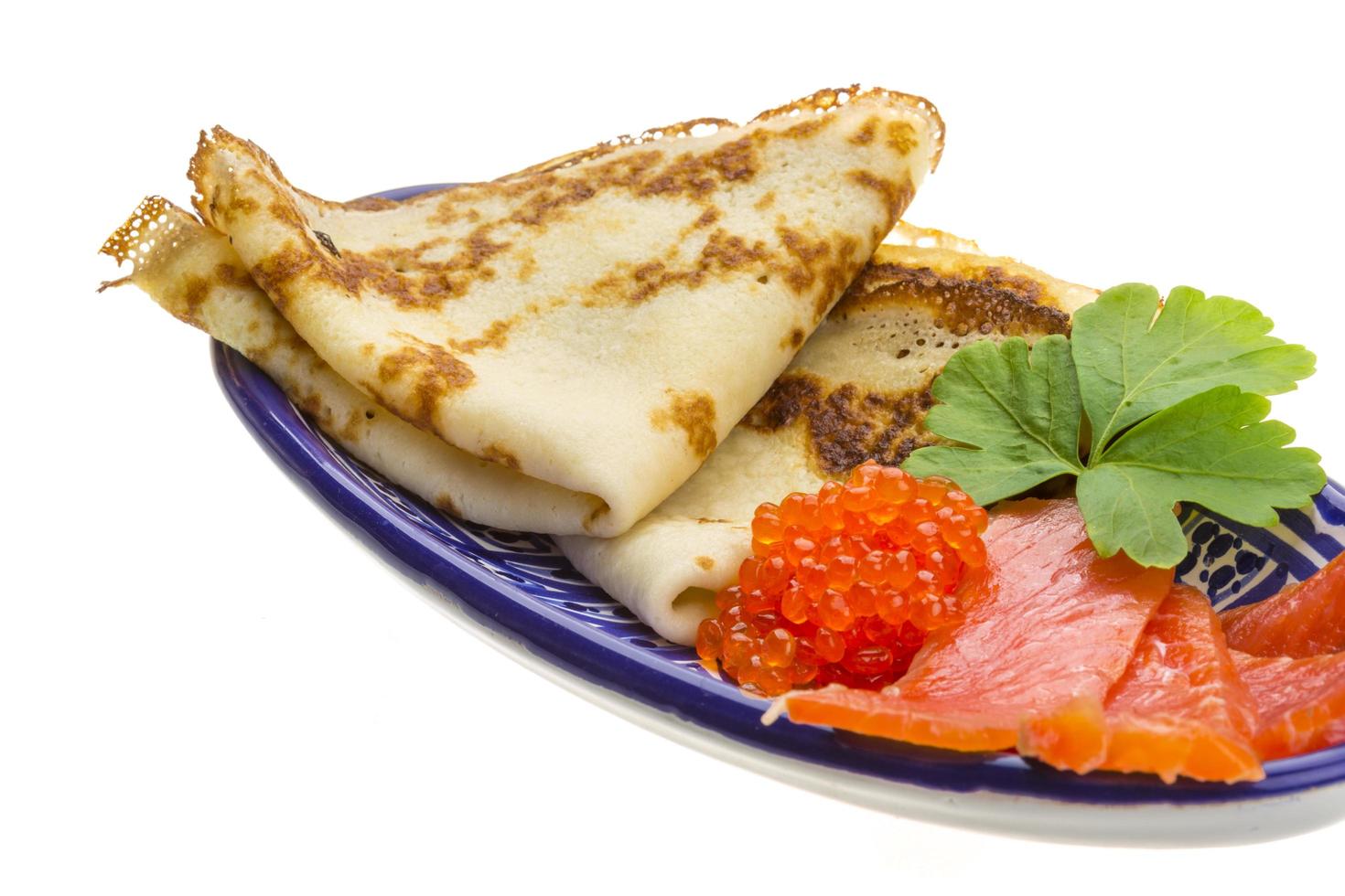 Russian pancakes in a bowl on white background photo