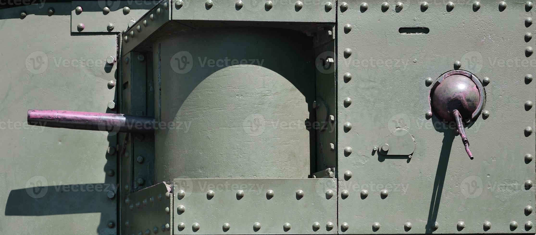 The texture of the wall of the tank, made of metal and reinforced with a multitude of bolts and rivets. Images of the covering of a combat vehicle from the Second World War with a guided machine gun photo