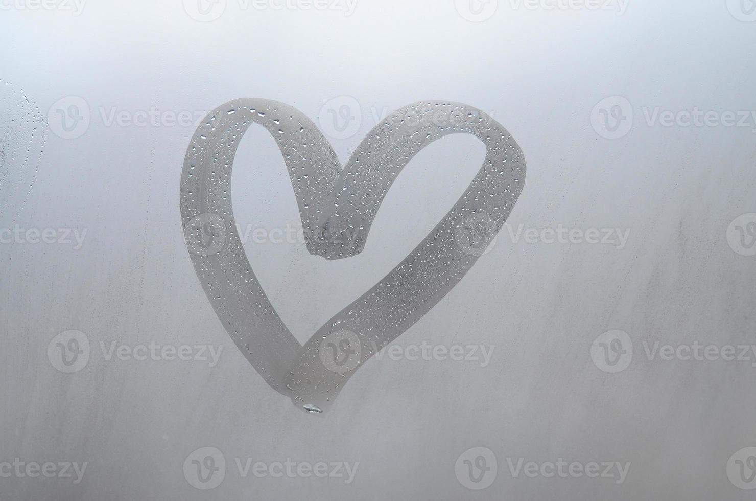 Autumn rain, the inscription on the sweaty glass - love and heart. Soft and beautiful background image with copy space photo