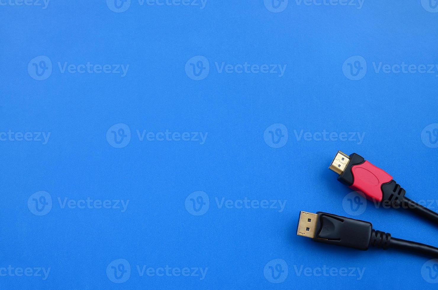 Audio video HDMI computer cable plug and 20-pin male DisplayPort gold plated connector for a flawless connection on a blue background photo