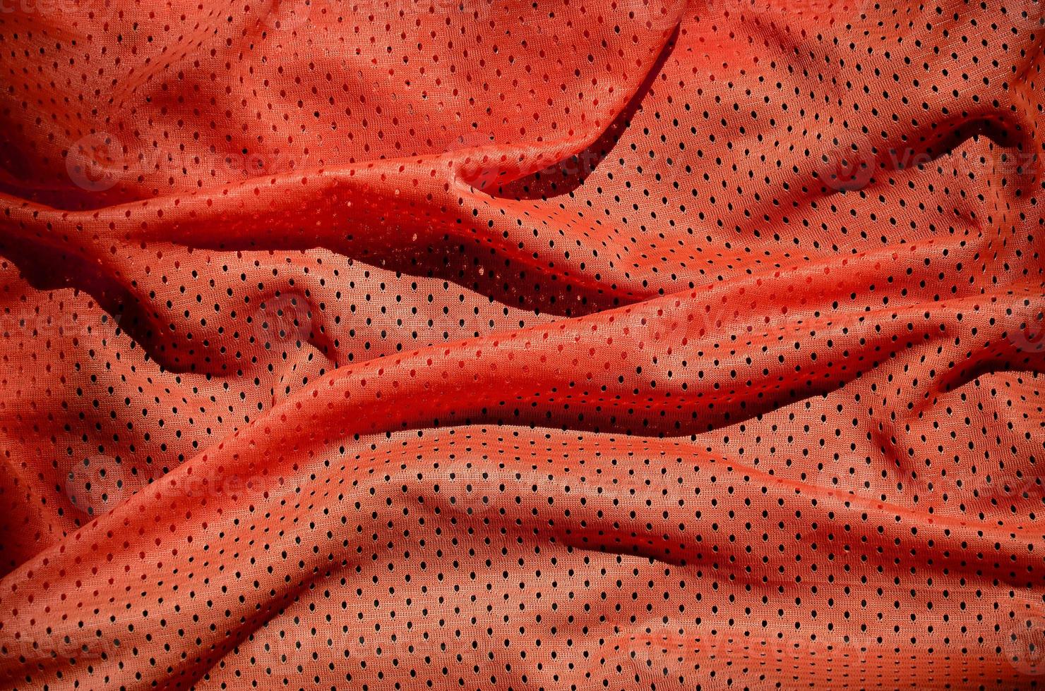 Close up of red polyester nylon sportswear shorts to created a textured background photo