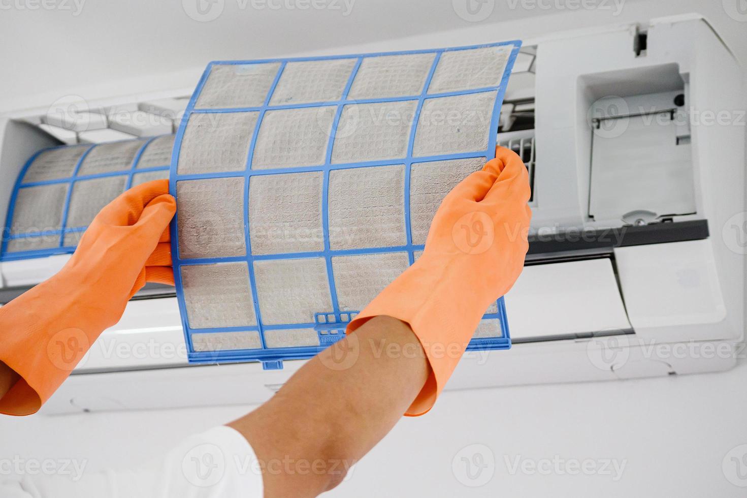 Asian man cleaning air conditioner dirty filter photo