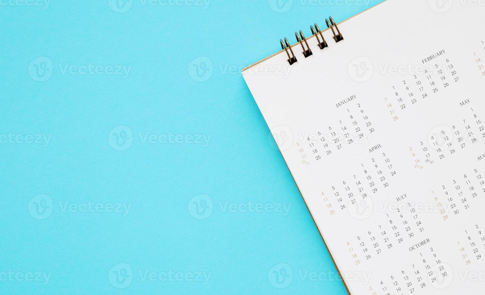 calendar page close up on blue background business planning appointment meeting concept photo