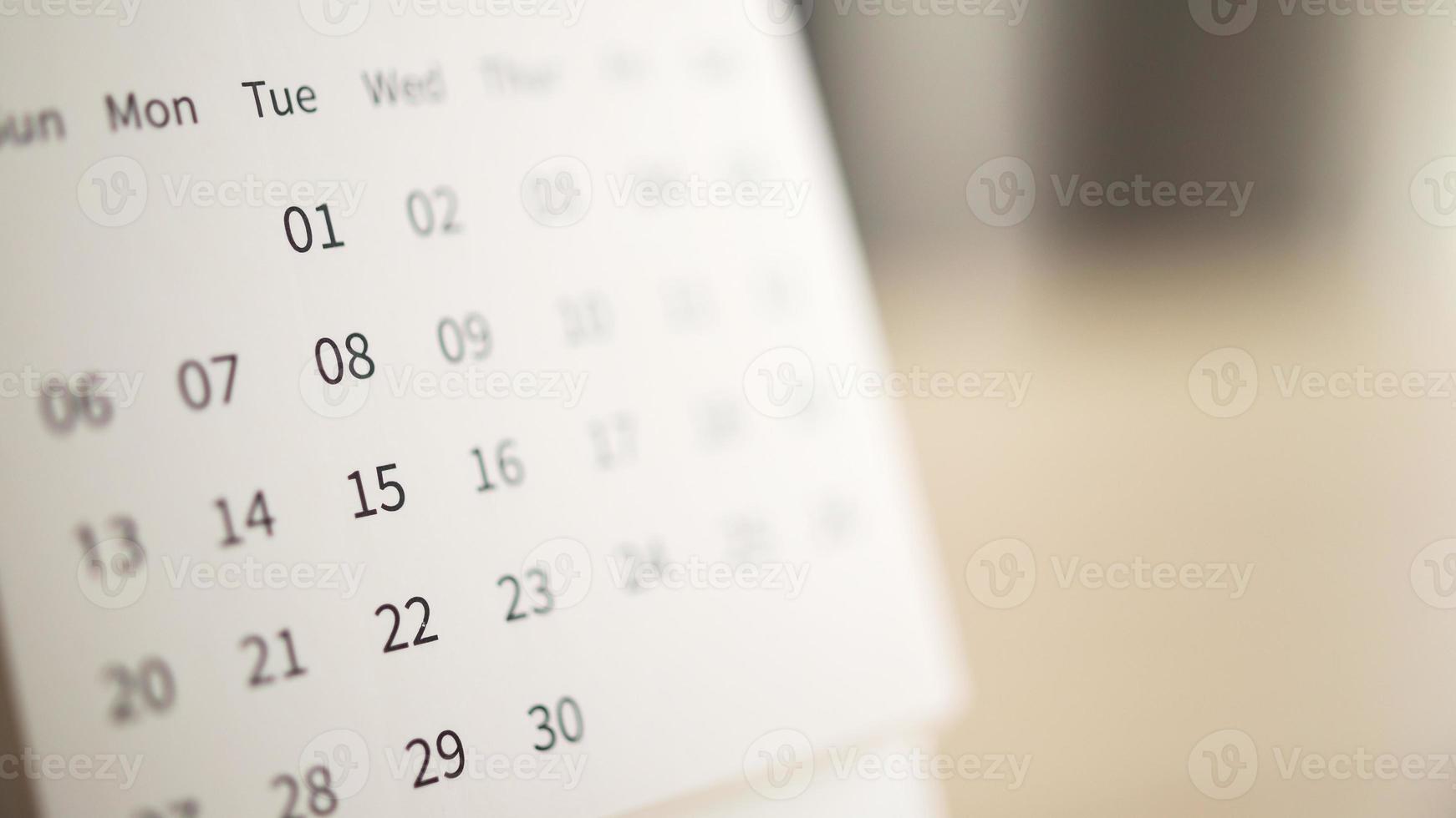 calendar page close up on wood table background business planning appointment meeting concept photo