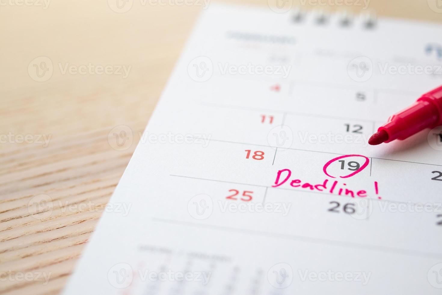 Deadline write on white calendar page date close up photo