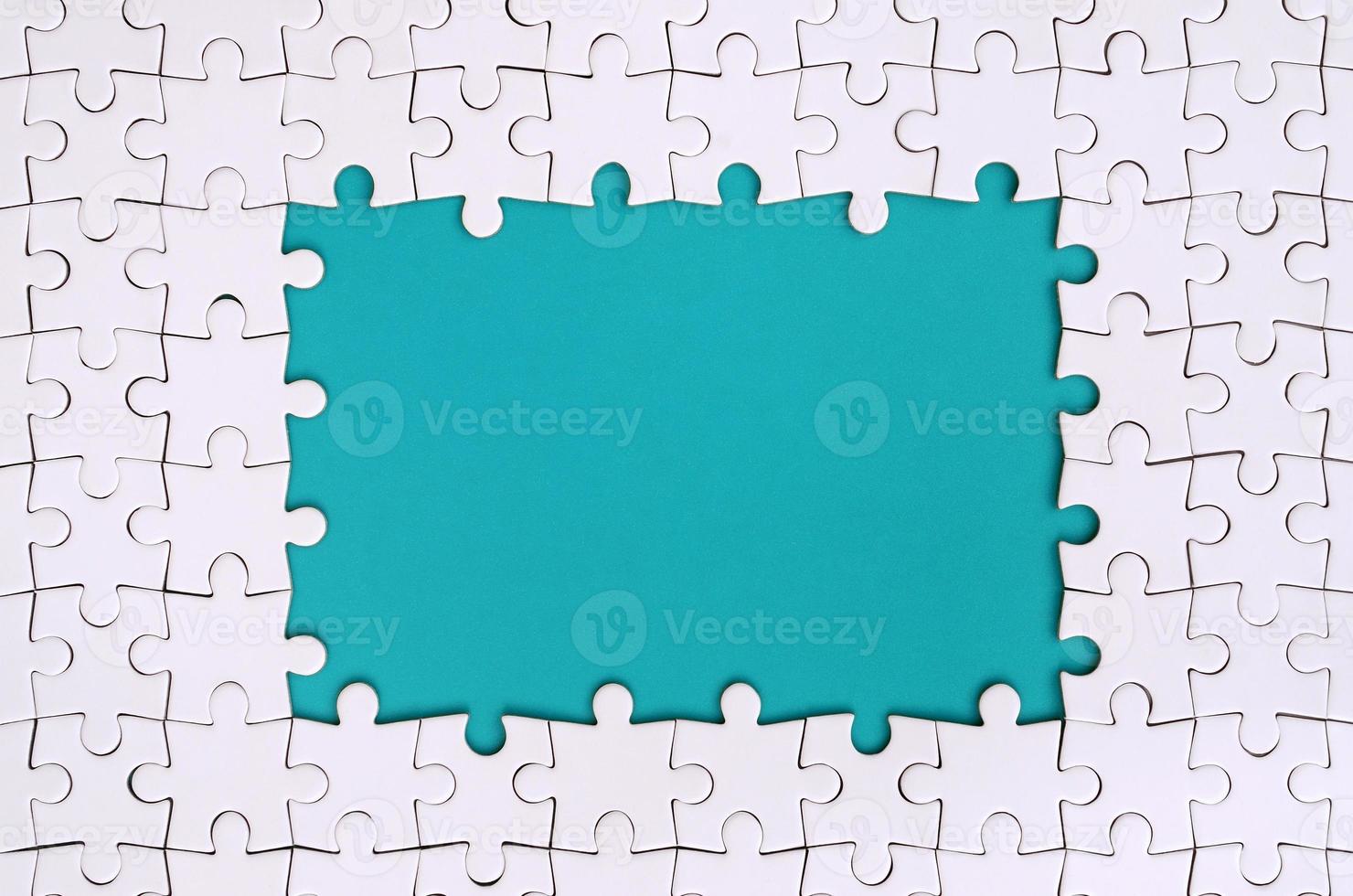 Framing in the form of a rectangle, made of a white jigsaw puzzle around the blue space photo