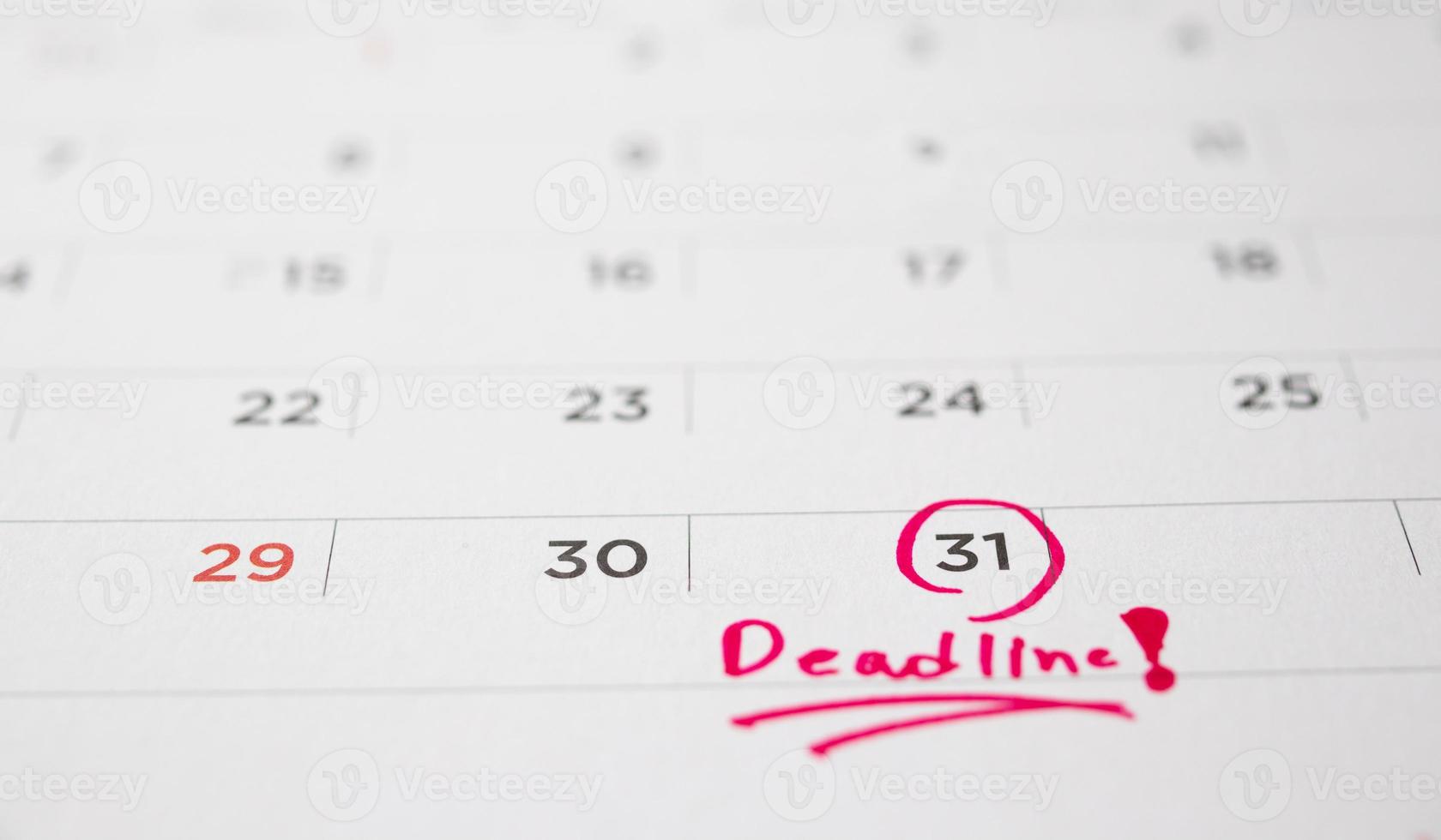 Deadline write on white calendar page date close up photo