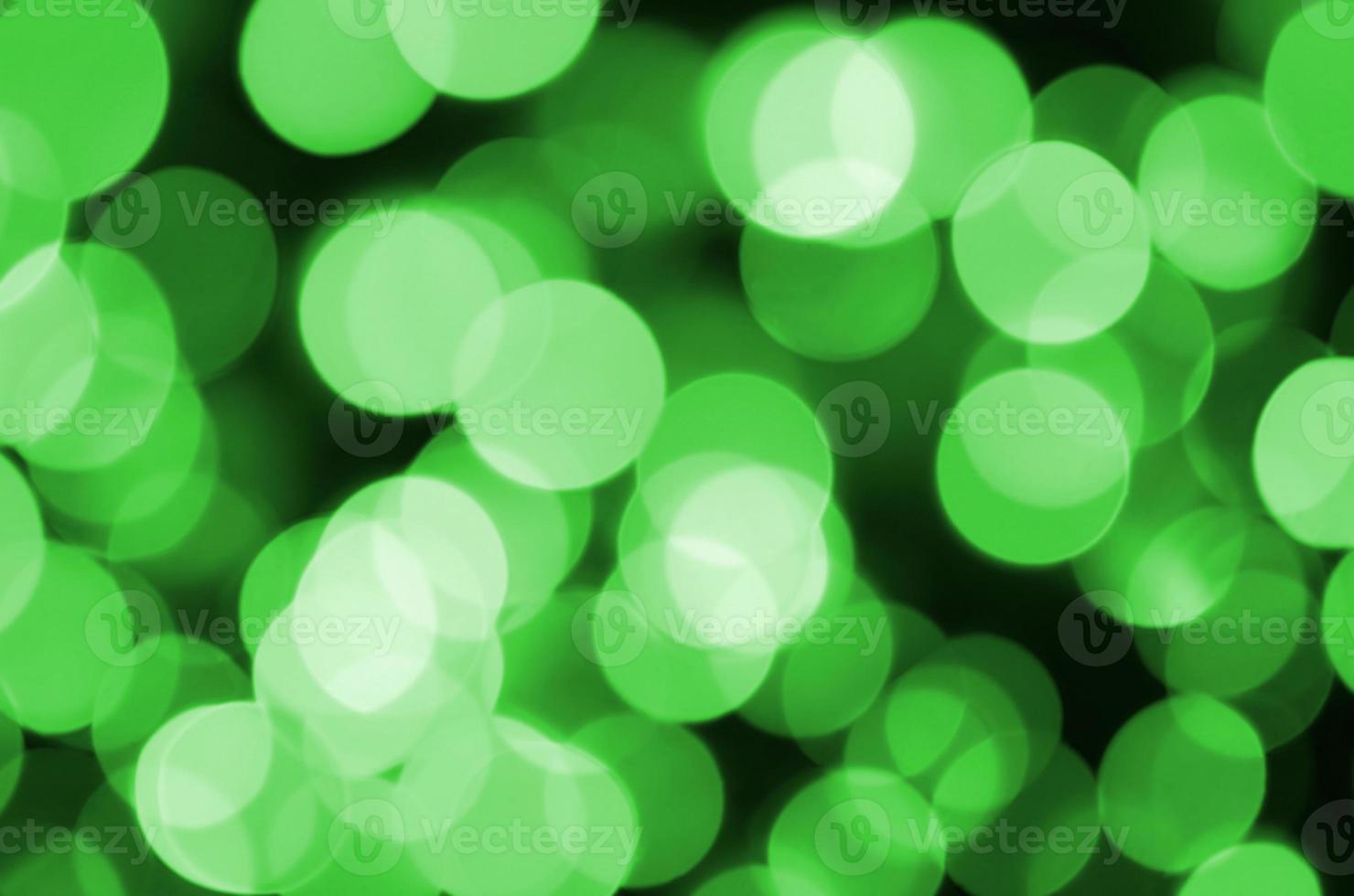 Green abstract Christmas blurred luminous background. Defocused artistic bokeh lights image photo