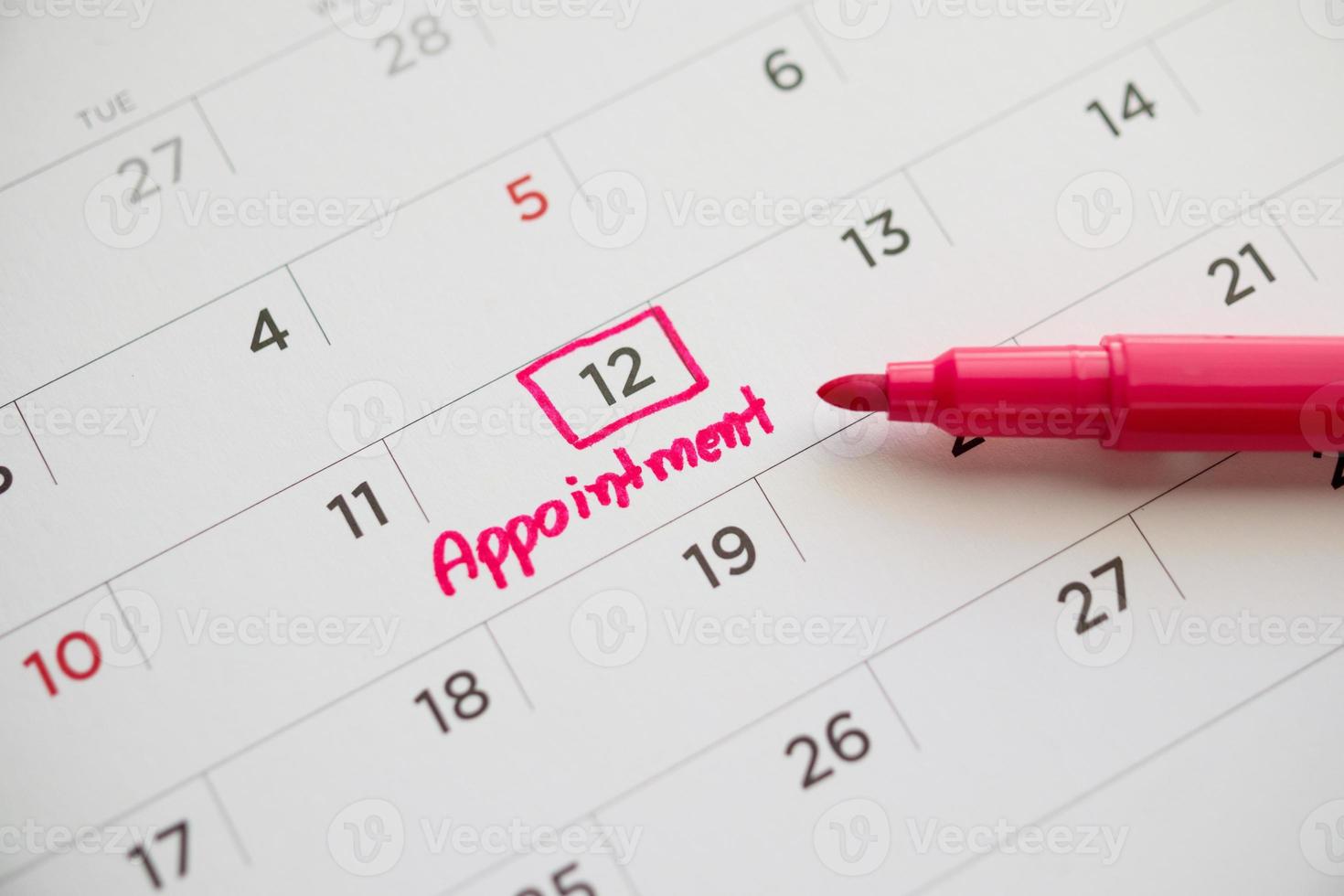 important appointment schedule write on white calendar page date close up photo