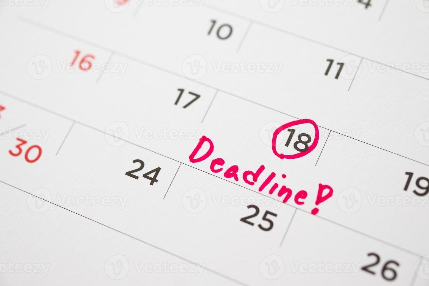 Deadline write on white calendar page date close up photo