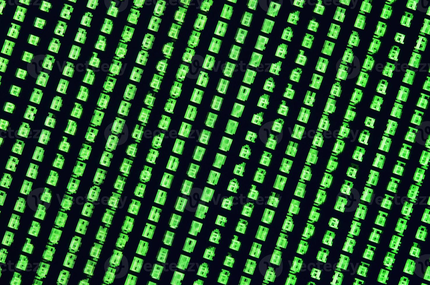 Macro shot of a glitch on the monitor of an office computer. The concept of introducing a virus into a personal data keeper. Stream of random green symbols on a black background photo