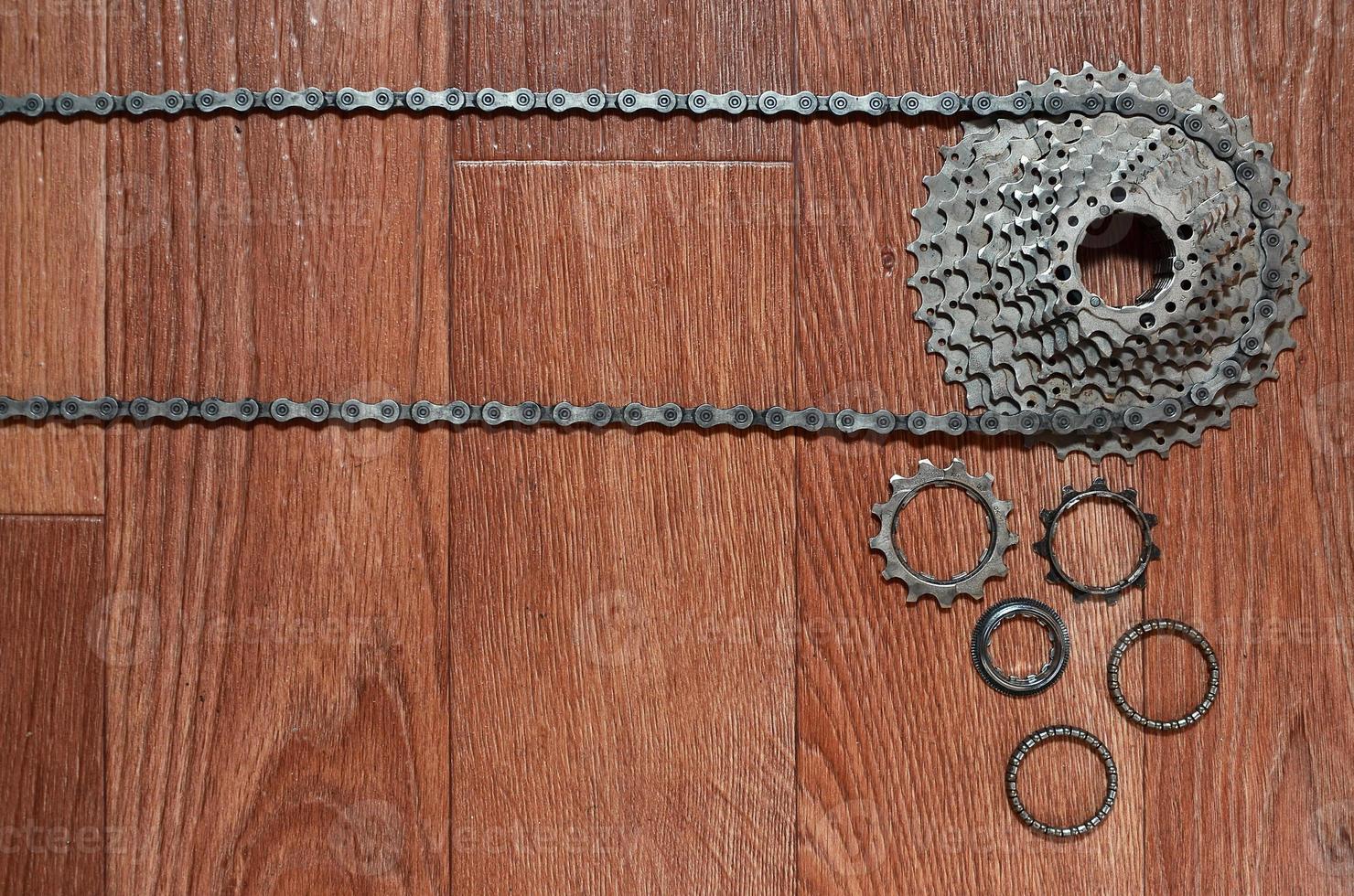 Some composition of a bicycle chain, several sprockets and other components of a sports bike photo