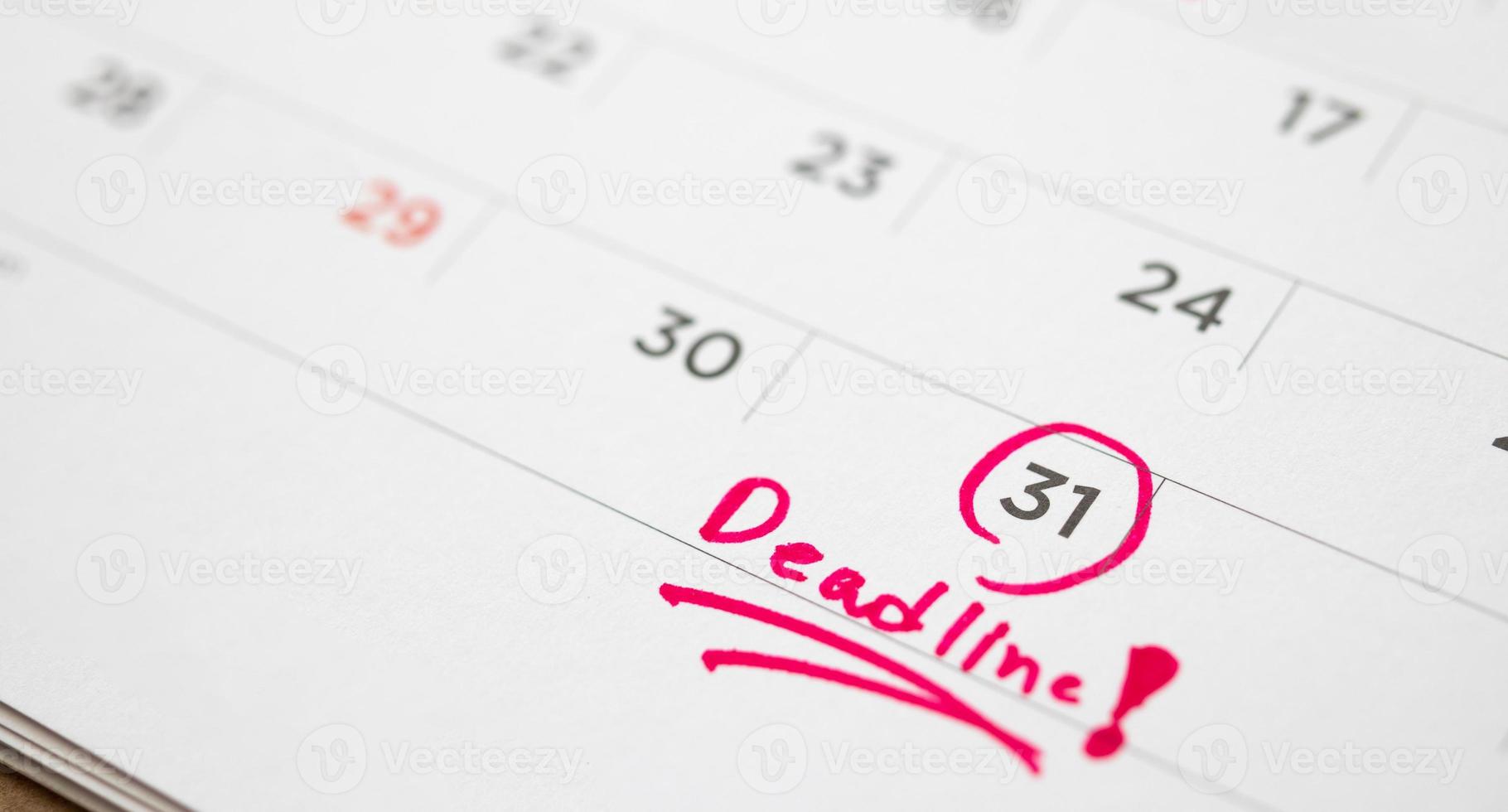 Deadline write on white calendar page date close up photo