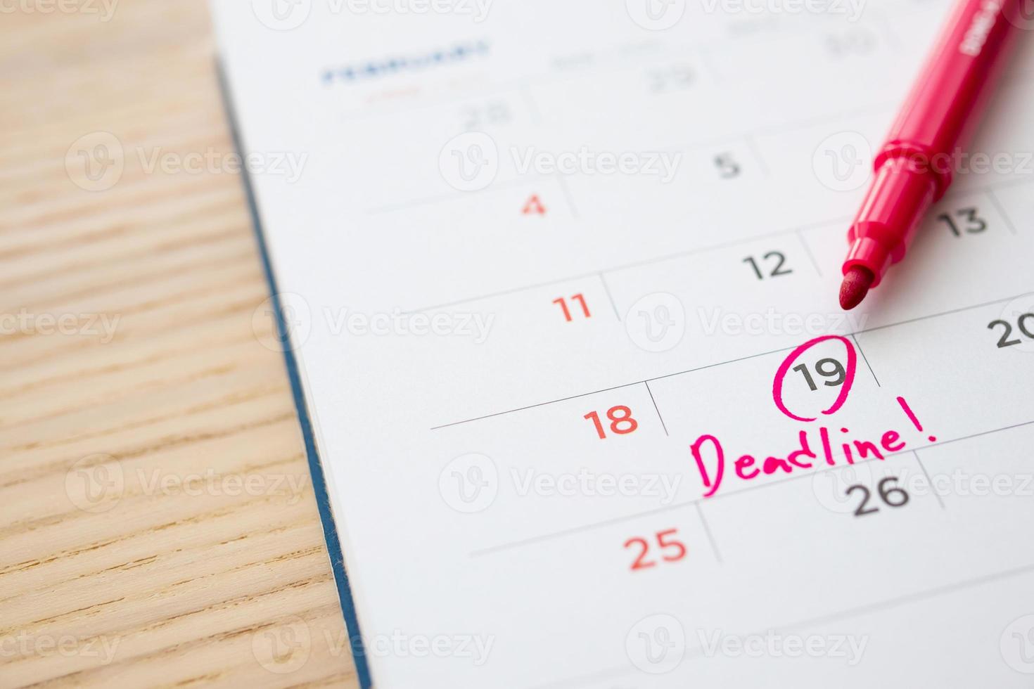 Deadline write on white calendar page date close up photo