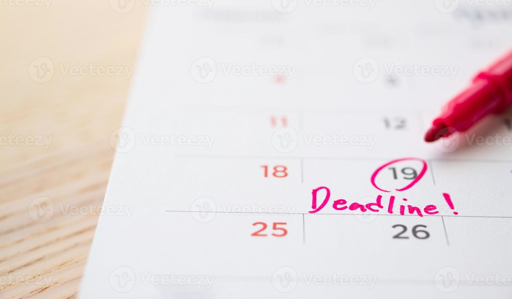 Deadline write on white calendar page date close up photo