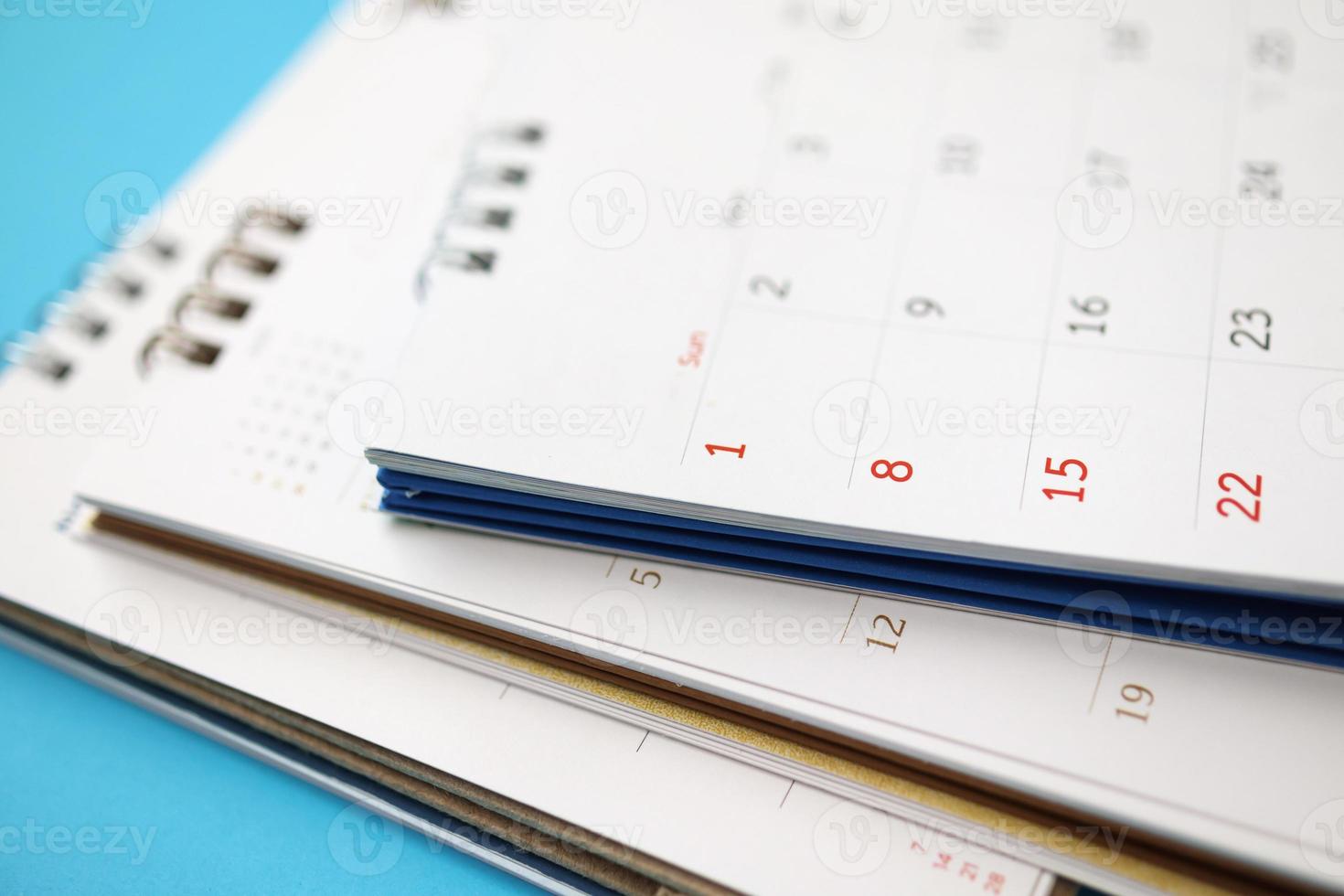 calendar page close up on blue background business planning appointment meeting concept photo